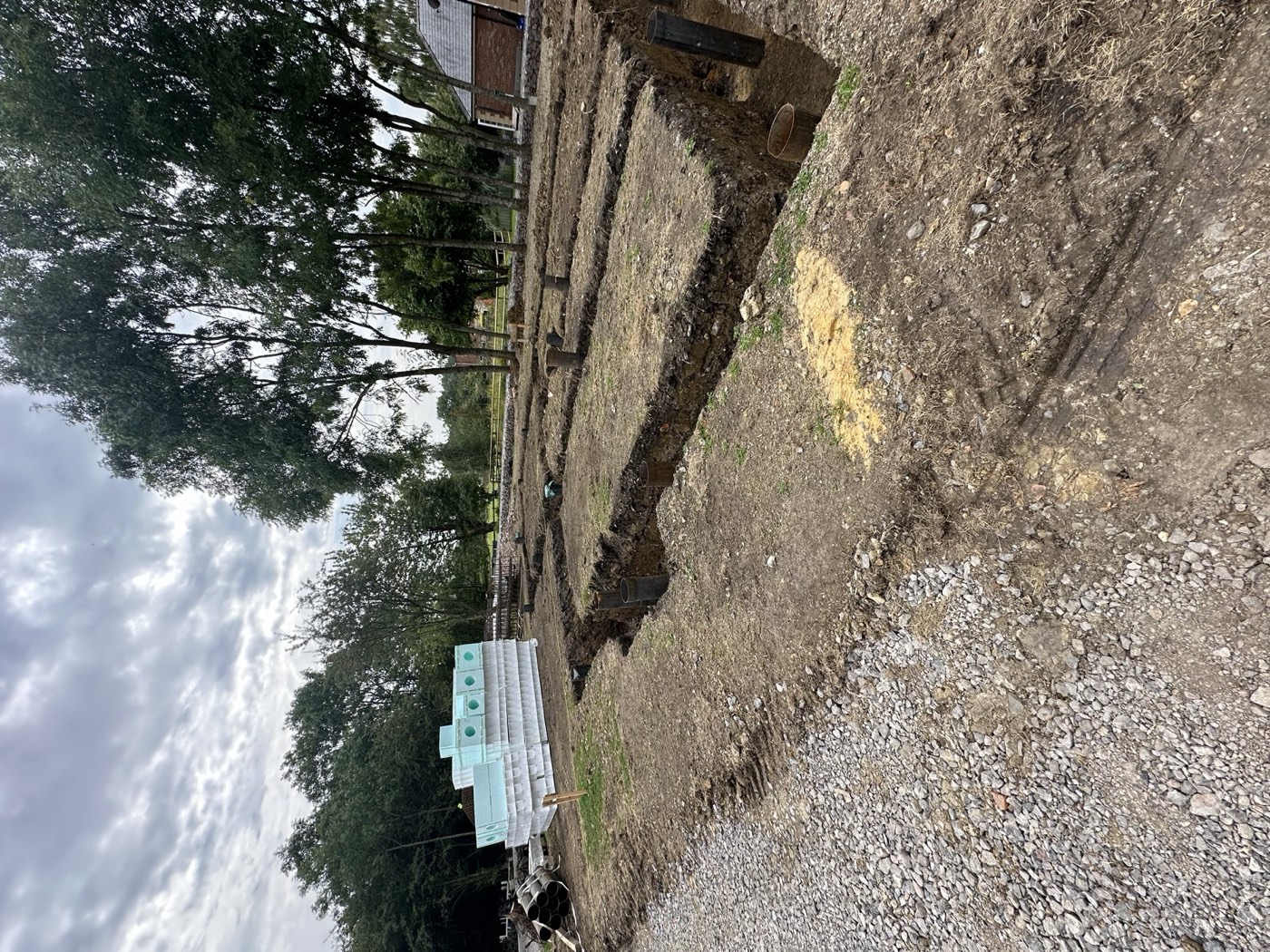 Foundation trenches with block piling visible