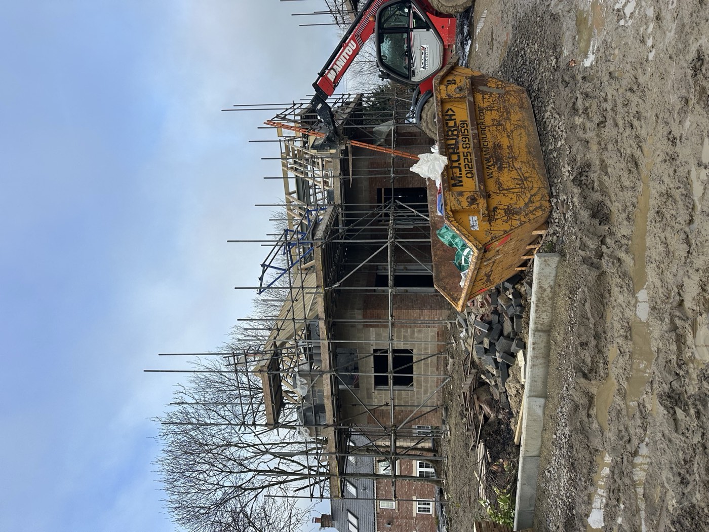 Crane lifting materials to roof level